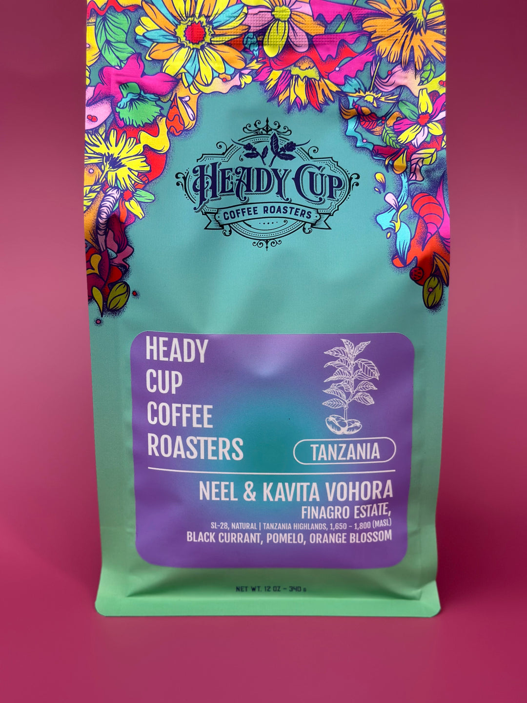 Heady Cup Coffee Roasters packaging with colorful floral design on a pink background