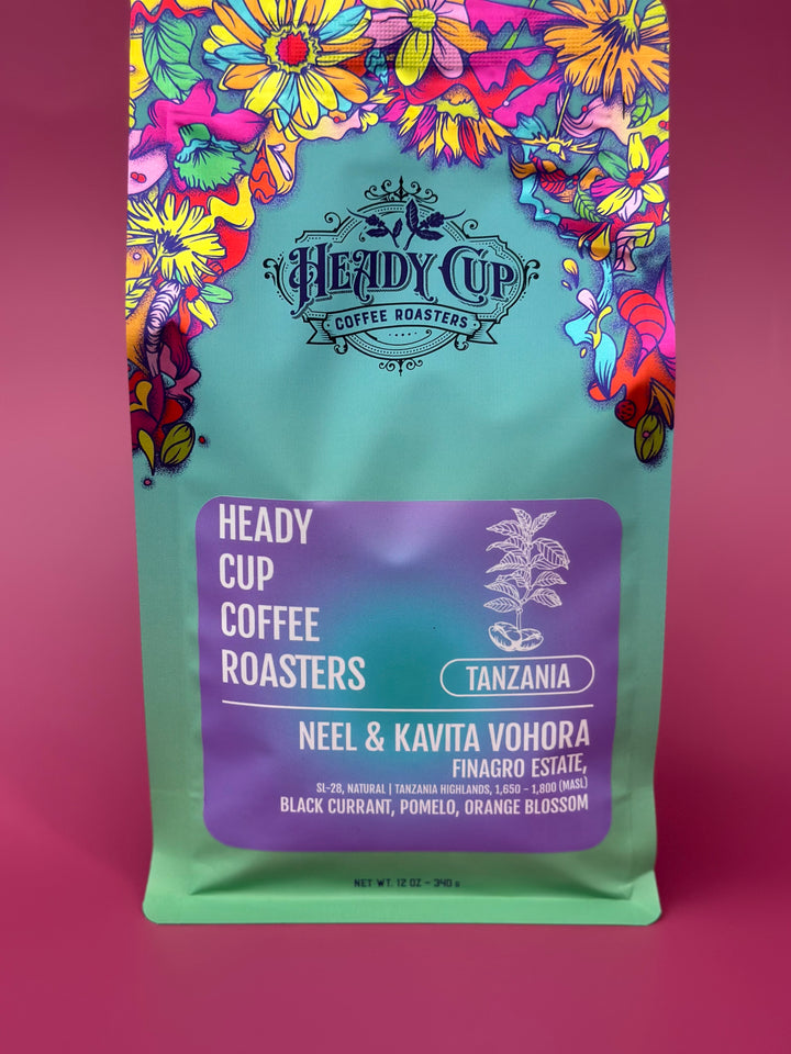 Heady Cup Coffee Roasters packaging with colorful floral design on a pink background