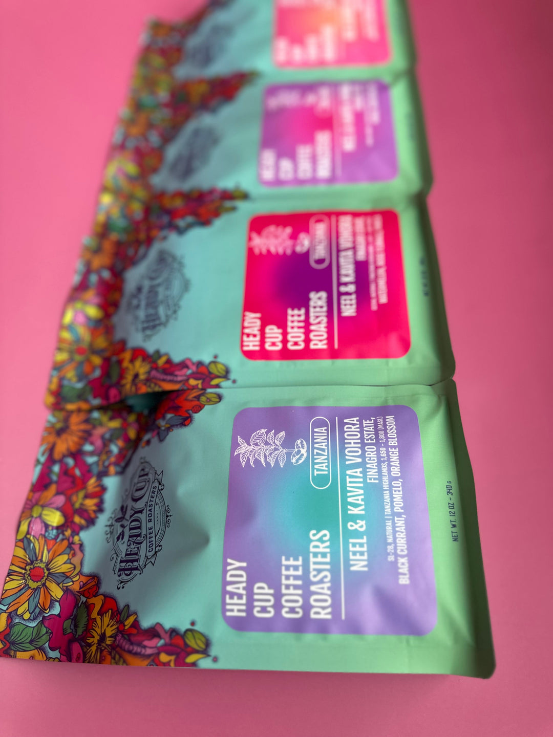 Packaged coffee of Heady Cup Coffee Roasters Tanzania Box Set on a pink background