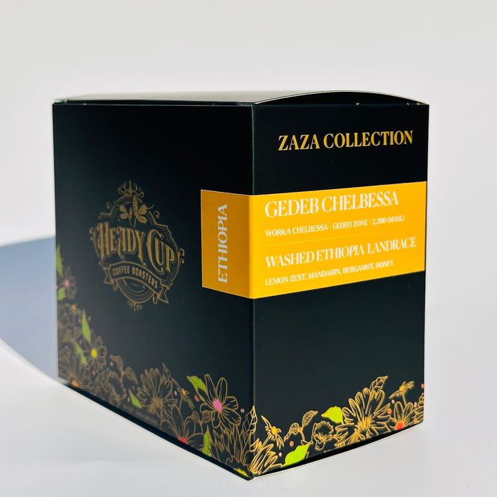 A black Heady Cup Coffee Roasters Zaza Collection box of Ethiopia Coffee. Label is yellow and box is against a pink background. 