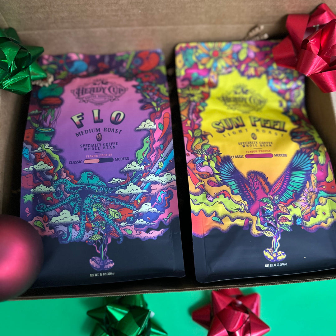 A picture of two colorful Heady Cup Coffee Roasters bags in a  two blend gift box