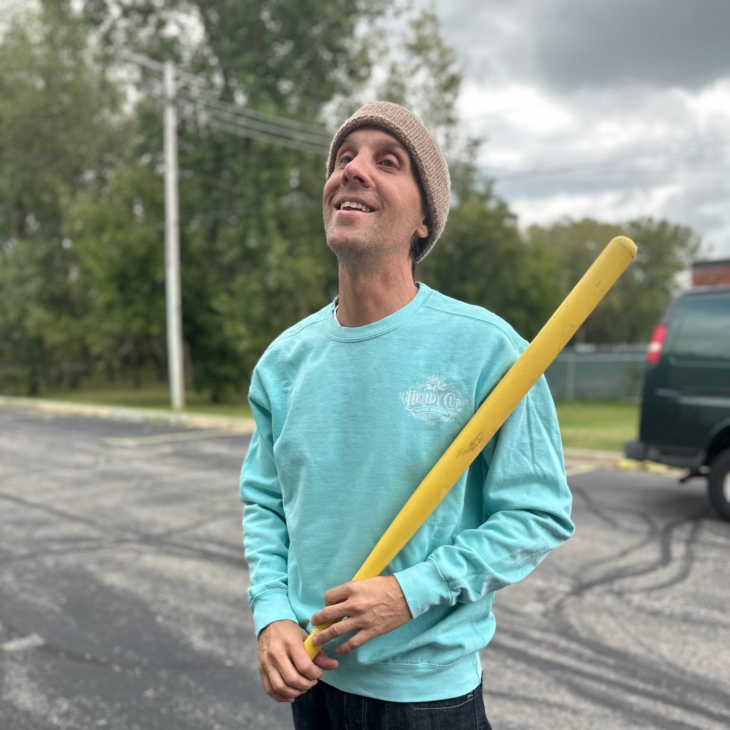 Kurtis wearing a teal Heady Cup Coffee Roasters definition crewneck sweatshirt. 