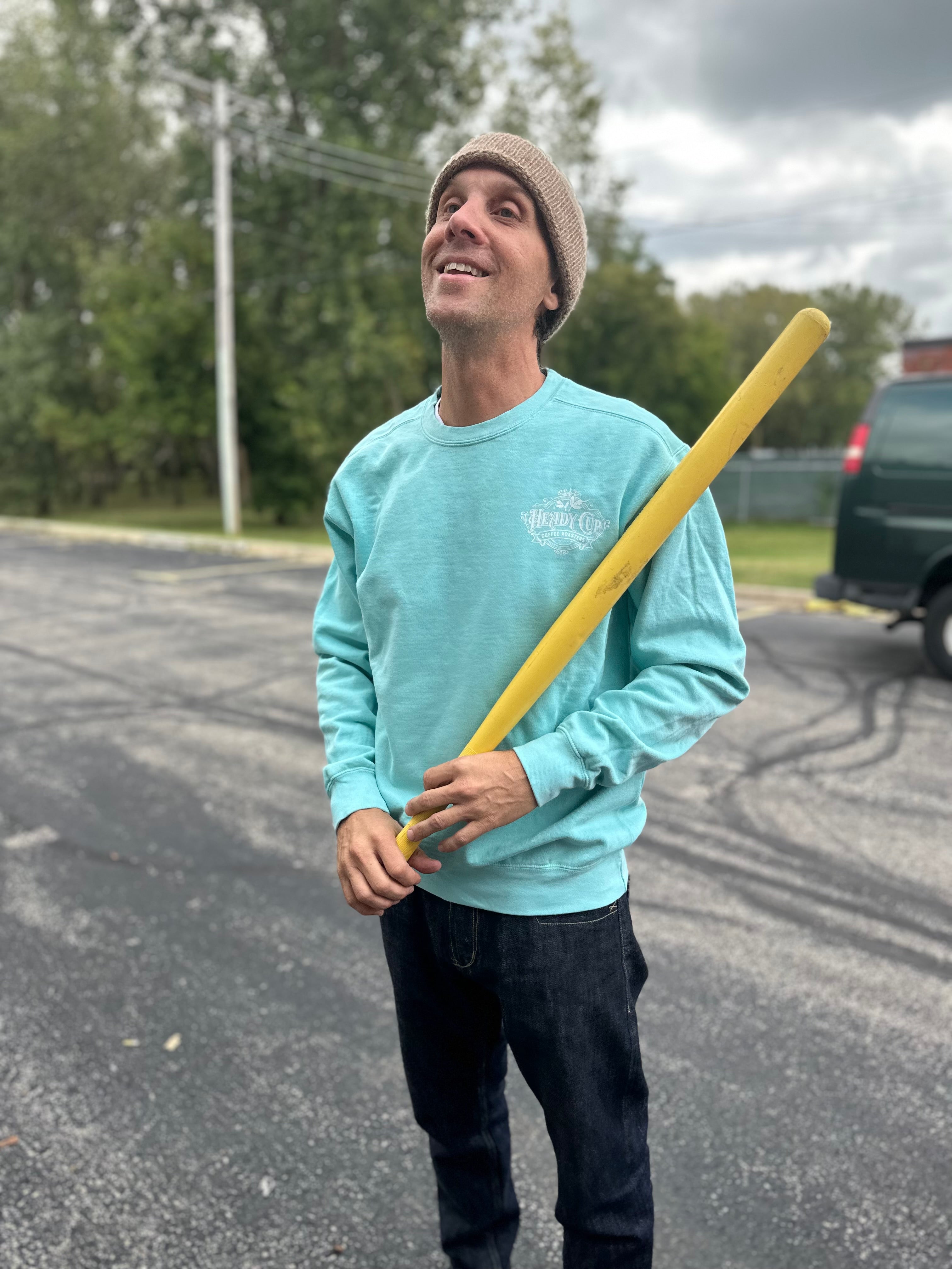 Kurtis wearing a teal Heady Cup Coffee Roasters definition crewneck sweatshirt. 