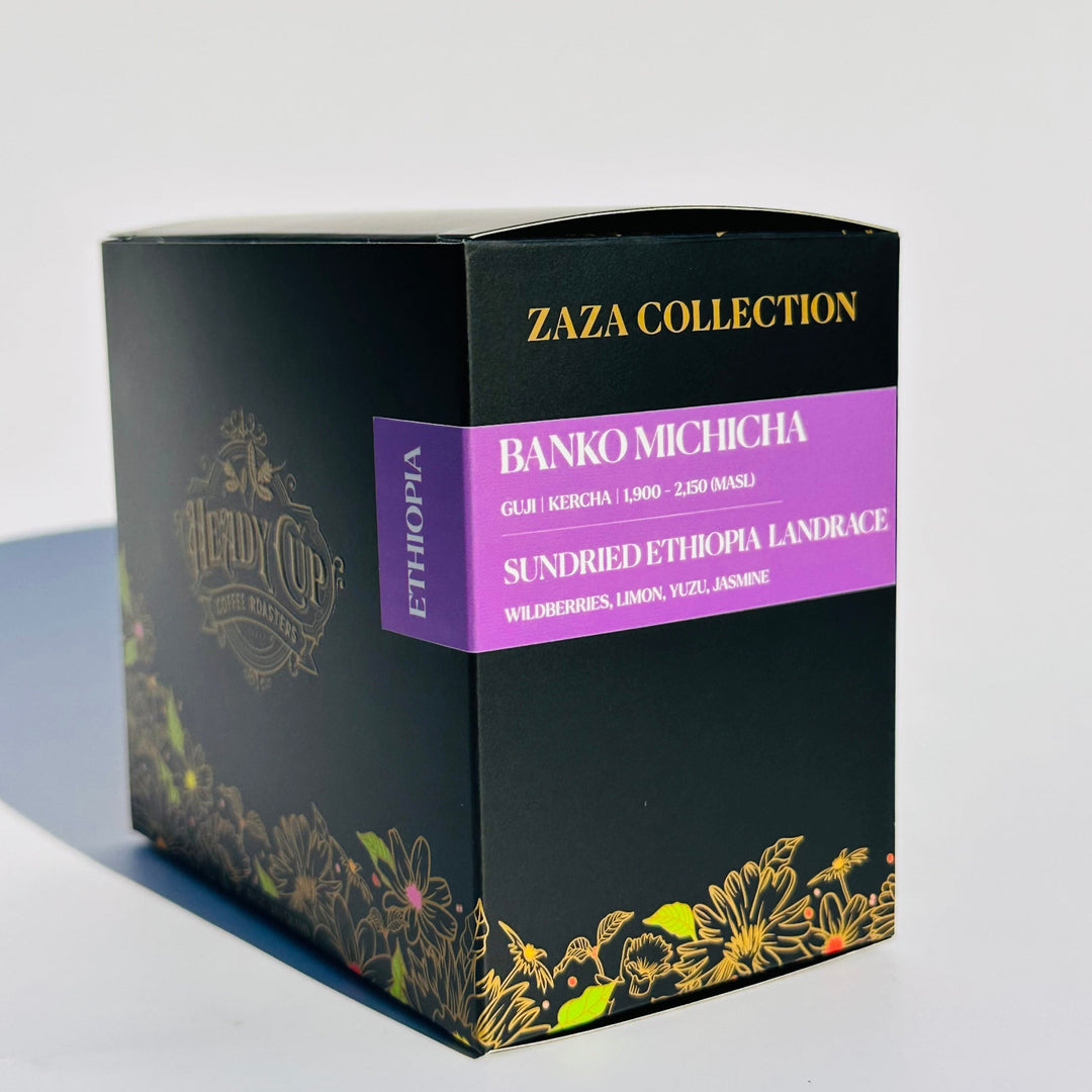 A black Heady Cup Coffee Roasters Zaza Collection box of Ethiopia Coffee. Label is purple and box is against a white background. The label reads wildberries, limoon, yuzu, and jasmine. 