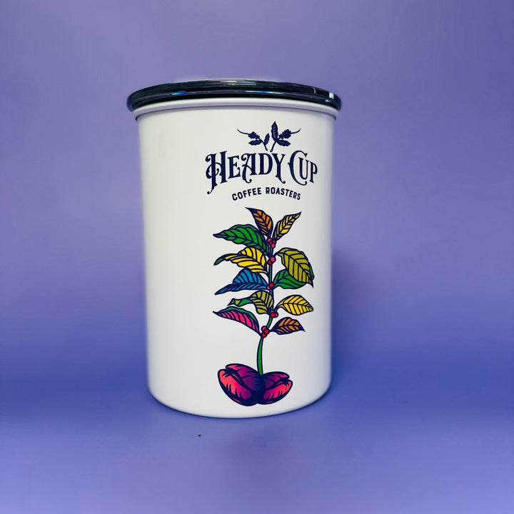 White Airscape tumbler with colorful leaf design and 'Heady Cup Coffee Roasters' branding on a purple background