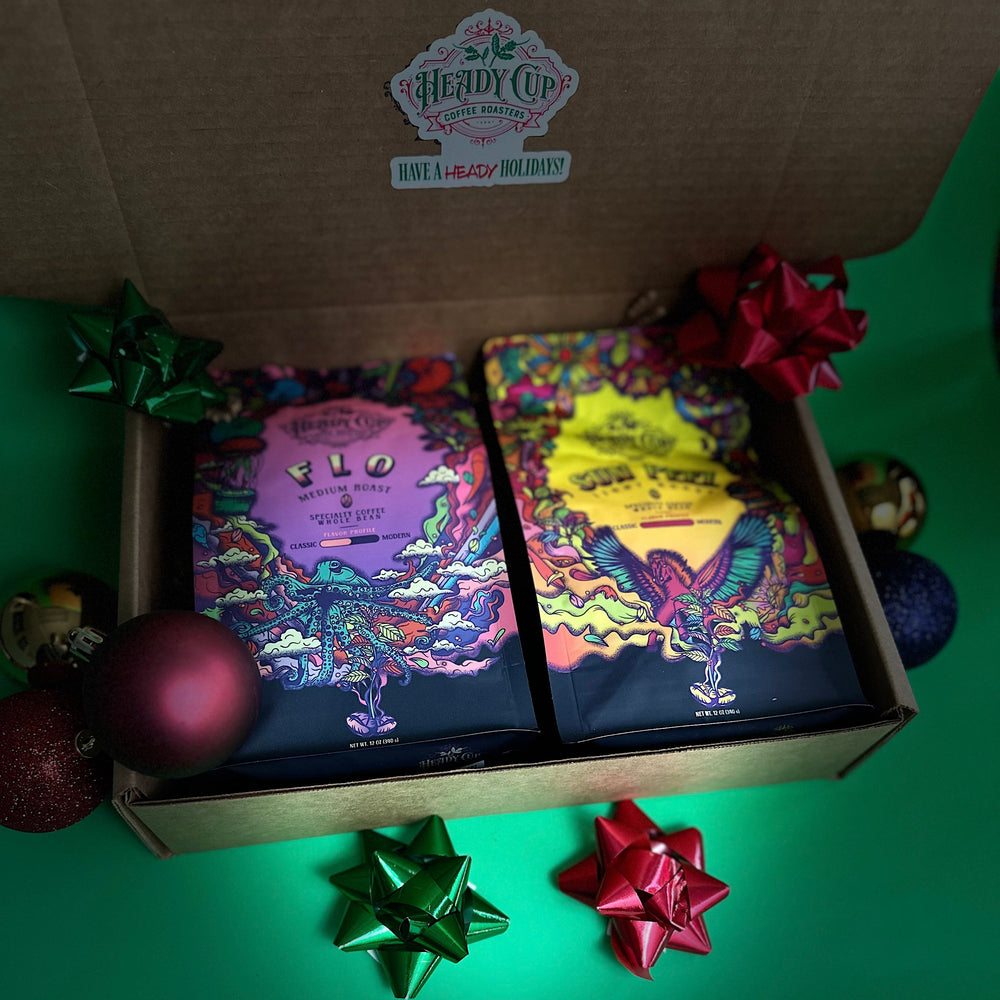 A picture of two colorful Heady Cup Coffee Roasters bags in a  two blend gift box