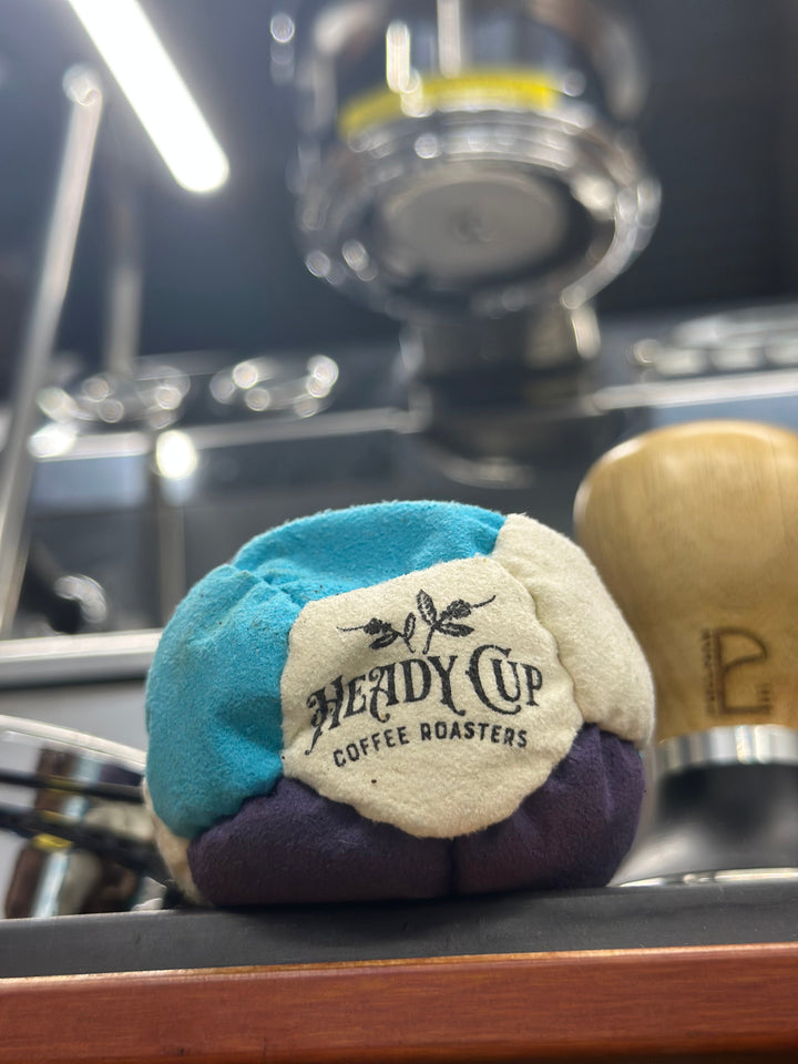 Heady Cup Coffee Roasters Foot Bag pictured beneath a grouphead