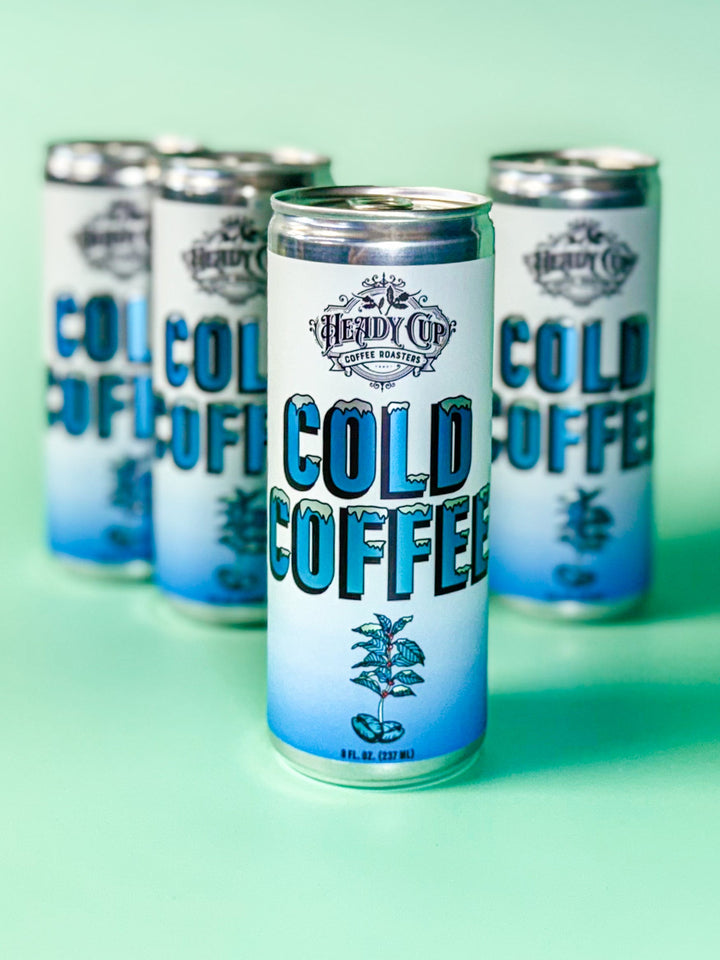 Cans of Heady Cup Coffee Roasters Cold Coffee on a light green background