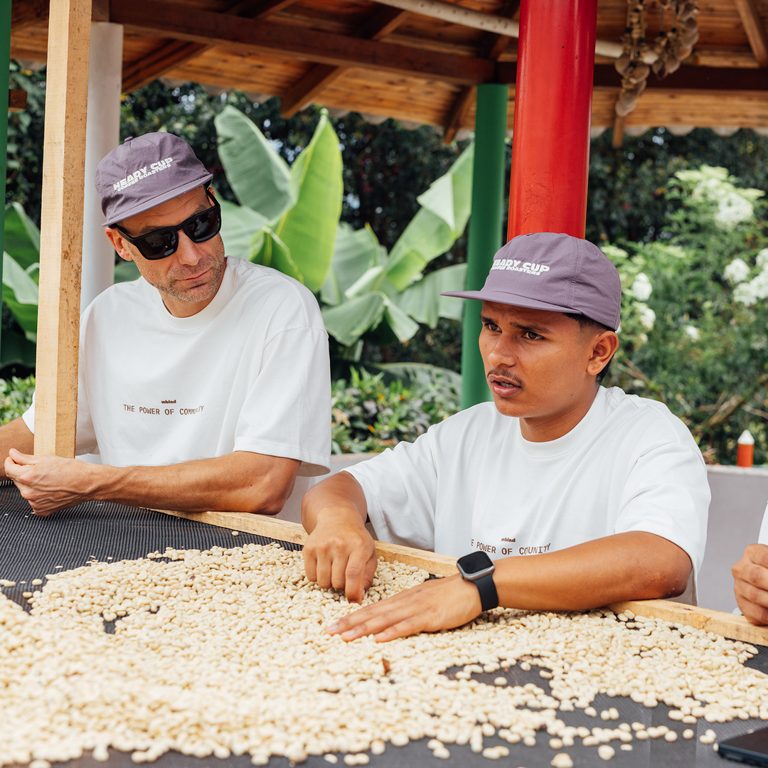 Michael Kivland and Colombian producer, Marlon Bolaños discussing about coffee while standing over a coffee drying bed. 