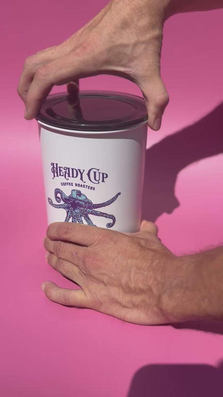 The Lid being removed from a heady Cup Coffee Roasters Airscape container.